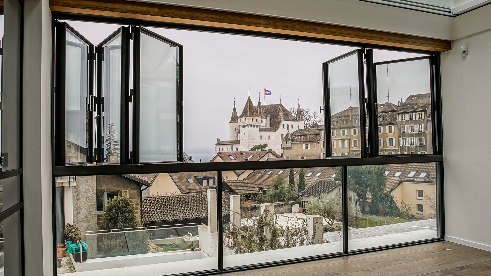 Looking outside at a castle Nyon, Geneva through open MHB folding door