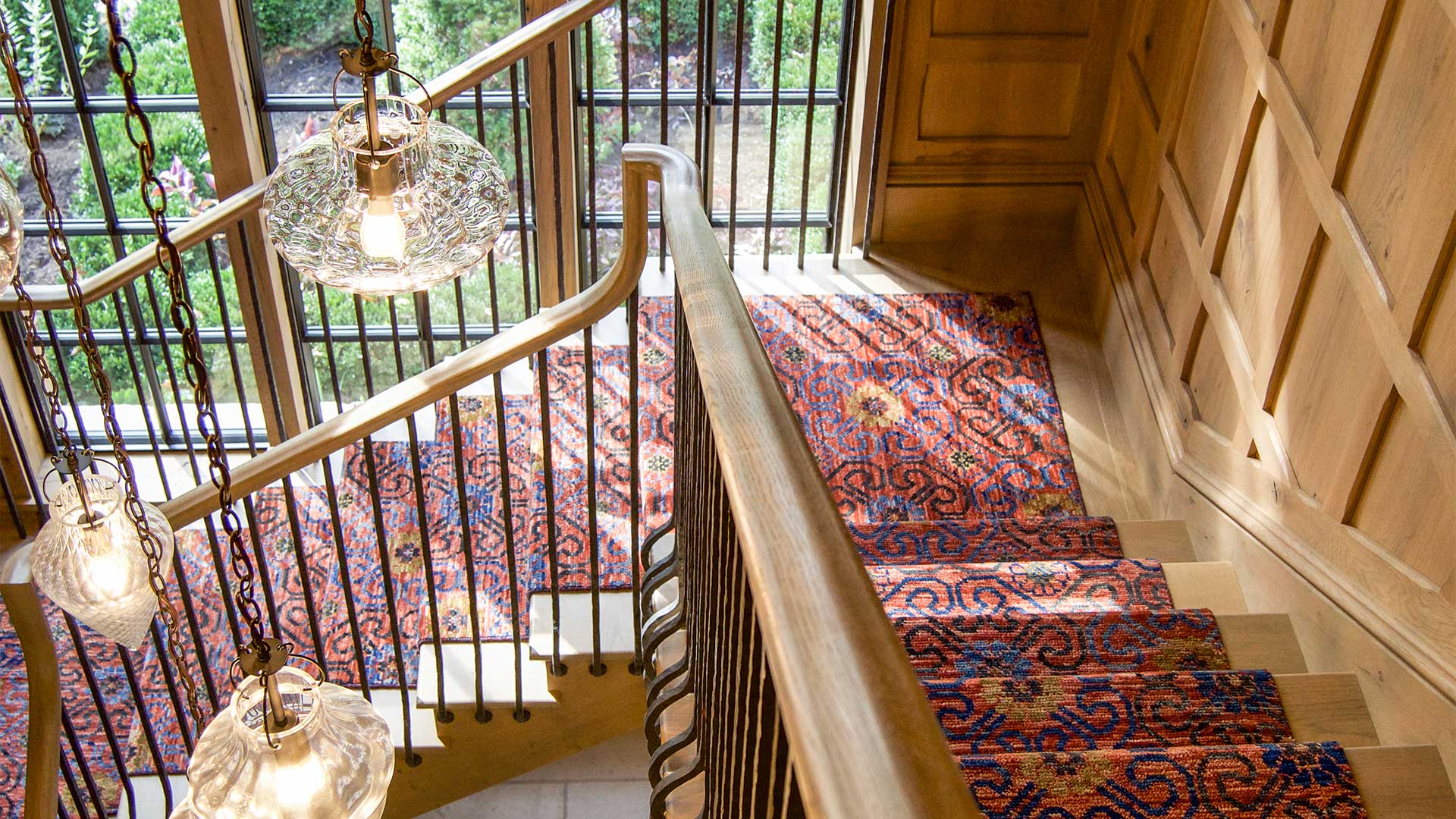 Wooden stairs with carpet and steel windows